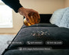 Person pouring liquid onto a black modular sofa with vegan performance weave fabric, highlighting spill-resistant, pet-friendly, and easy-clean living room seating.
